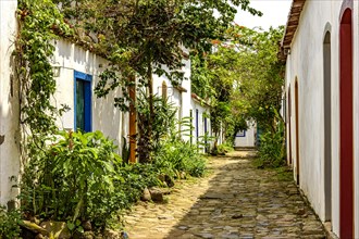 Beutiful street of the historic city of Paraty with its cobblestones and old colonial-style houses with a facade decorated with plants and flowers
