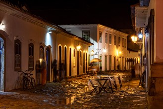 Night view of the city of Paraty with its old colonial style houses and the brightness and colors of the city lights reflected in the cobbled streets