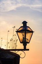 Old street lighting with lantern in colonial style during sunset in the city of Ouro Preto