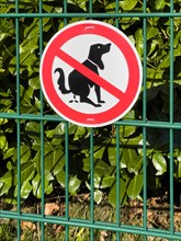 Prohibition sign on garden fence for dog owners against wild defecation of dog dog excrement dog poop