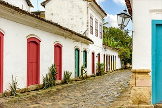 Street with cobblestone pavement and facades of old colonial houses in the historic city of Paraty in the state of Rio de Janeiro