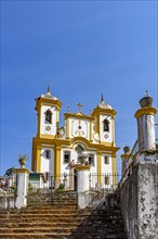 Facade of a historic church in Ouro Preto with blue sky in the background on sunny days