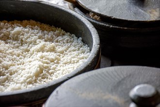 Clay pots with white rice prepared on the wood stove and ready to serve