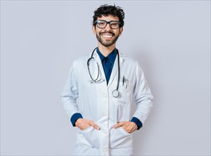 Smiling doctor on isolated background. Happy doctor with hands in pockets. Portrait of smiling young doctor isolated