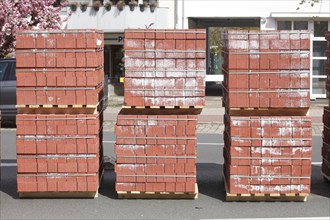 Stacked red building blocks on a construction site for a bicycle path