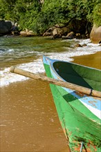 Rowing fishing boat on the shore of the unspoiled beach of Ilha Grande
