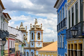 Colorful facades of old houses and historic church in Pelourinho neighborhood in Salvador city