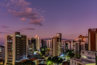 Neighborhood of the city of Belo Horizonte in Minas Gerais with its buildings lit up by the sunset