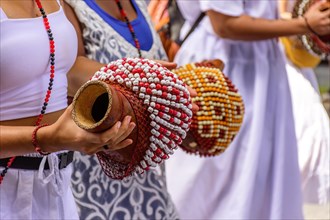 Woman playing a type of rattle called xereque of African origin used in the streets of Brazil during samba performances at traditional carnival festivities