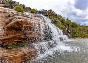 Waterfall among the rocks and vegetation of the Biribiri environmental reserve in Diamantina