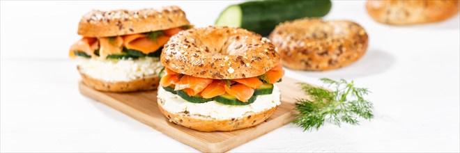 Bagel sandwich for breakfast topped with salmon fish on a board Panorama in Stuttgart
