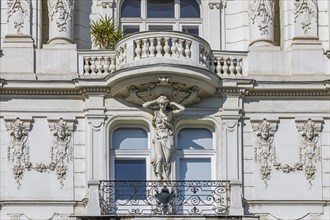 Baroque statue as support of a balcony on the left Wienzeile