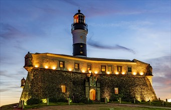 Image of the Farol da Barra lighthouse during sunset in summer at Salvador city