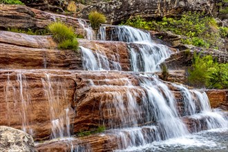 Water blur on beautiful and small waterfall among the rocks and vegetation of the Biribiri environmental reserve in Diamantina