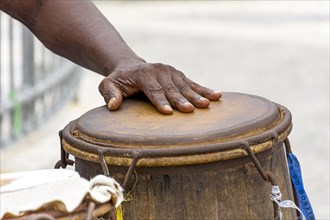 Percussionist playing a rudimentary atabaque during afro-brazilian capoeira fight at Pelourinho on Salvador city
