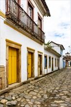 Bucolic street in the historic city of Paraty in the state of Rio de Janeiro with cobblestone pavement and colonial style houses