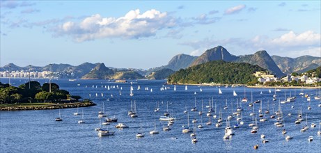 Panoramic image of Guanabara Bay with its boats and surrounded by the city of Rio de Janeiro with its hills during the afternoon