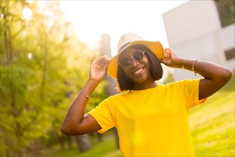 Golden Hour: A Beautiful Black Woman Basks in the Warmth of Summer in the Forest