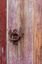 Detail of antique colorful wooden door and lock deteriorated by time and rust in a colonial style house in the historic city of Diamantina in Minas Gerais