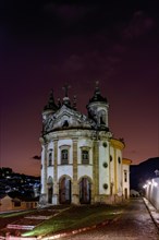 Old baroque church illuminated at dusk in the historic town of Ouro Preto in Minas Gerais