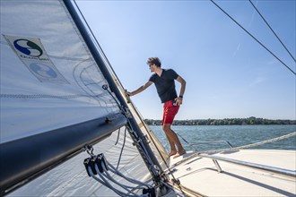 Young man sailing on a sailboat
