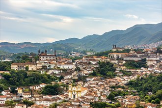 View of the historic city of Ouro Preto in Minas Gerais with its colonial-style houses and churches and the mountains in the background