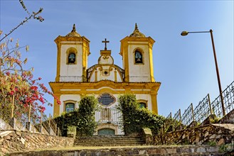 Bottom view of ancient stairs and historic church of 18th century colonial architecture on top of the hill in the city of Ouro Preto in Minas Gerais