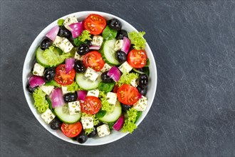 Greek salad with fresh tomatoes olives and feta cheese healthy eating food from above on slate with text free space in Stuttgart