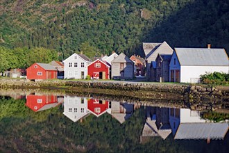 Wooden houses reflected in calm waters