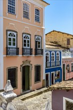 Old olorful facades of colonial-style houses on a cobblestone street in the Pelourinho neighborhood of Salvador