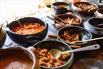 Traditional Brazilian food off the rgion off Minas Gerais being prepared in clay pots and in the old and popular wood stove