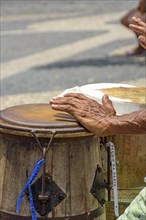 Percussionist playing a rudimentary atabaque during afro-brazilian cultural manifestation at Pelourinho on Salvador city