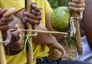 Musicians playing an instrument called berimbau during a capoeira performance in Salvador