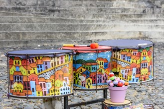 Ethnic and colorful decorated set of drums hand made painted on the streets of Pelourinho
