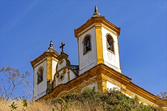 Bottom view of antique and historic church in 18th century colonial architecture on top of the hill in the city of Ouro Preto in Minas Gerais