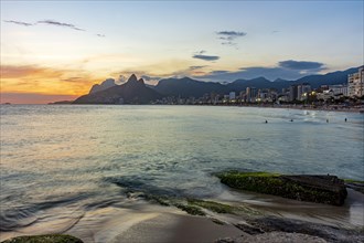 Beautiful sunset behind the mountains of the city of Rio de Janeiro on Ipanema beach
