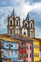 Historic baroque church towers rising between old colorful houses in the Pelourinho district in the city of Salvador