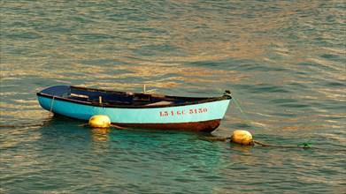 Turquoise small fishing boat