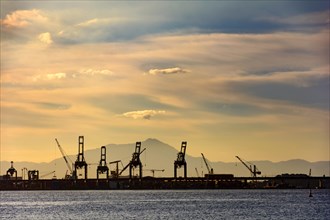 Silhouette of the harbor pier with its cranes seen during sunset on Rio de Janeiro