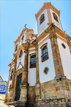 Historic baroque church and its towers seen from below in the famous city of Ouro Preto in Minas Gerais state