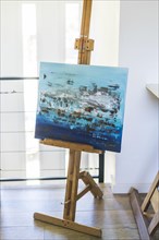An artist easel with a painted canvas