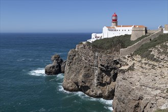 Rock cliffs on the Atlantic Ocean and historic lighthouse at Cape Cabo de Sao Vicente