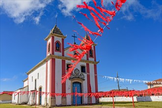 Old and simple colonial-style church decorated with ribbons for a religious celebration in the small town of Lavras Novas