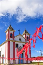 Small simple colonial-style chapel decorated with ribbons for a religious celebration in the small town of Lavras Novas