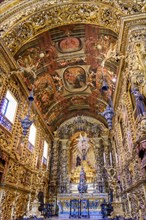 Interior and altar of a brazilian historic ancient church from the 18th century in baroque architecture with details of the walls in gold leaf in the city Rio de Janeiro