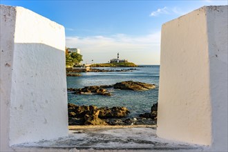 Famous Barra Lighthouse seen through the walls of the old fortress of Santa Maria in the city of Salvador in Bahia