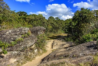 Trail through the rocks and vegetation used for expeditions in the hills around the city of Lavras Novas in Minas Gerais