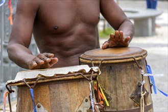 Musician playing atabaque which is a percussion instrument of African origin used in samba