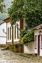 Colonial houses with colorful facades and cobblestone slopes in the historic city of Tiradentes