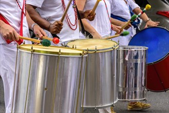 Several drummers with their musical instruments in the Carnival celebrations in the streets of Brazil
